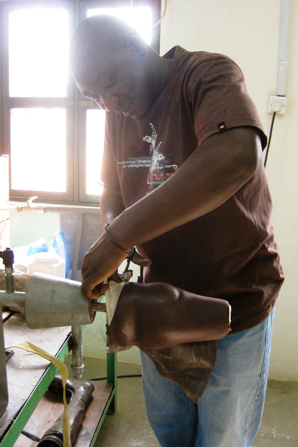 Edward cuts away excess plastic after it has cooled at the Physical Rehabilitation Reference Centre in Juba, South Sudan